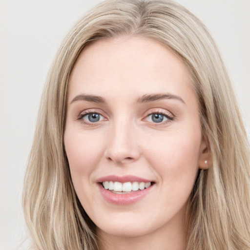 Joyful white young-adult female with long  brown hair and blue eyes