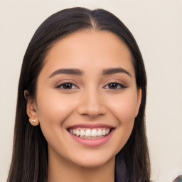 Joyful latino young-adult female with long  black hair and brown eyes