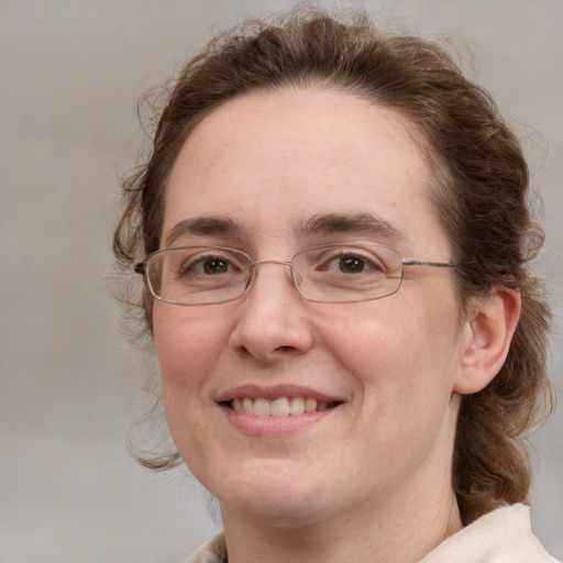 Joyful white adult female with medium  brown hair and grey eyes