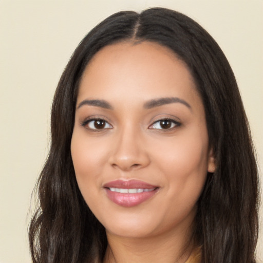 Joyful latino young-adult female with long  black hair and brown eyes