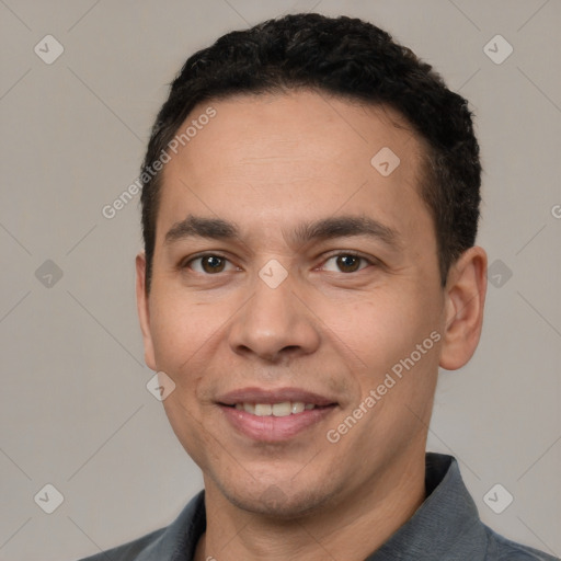 Joyful white adult male with short  black hair and brown eyes