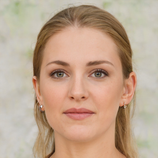 Joyful white young-adult female with medium  brown hair and blue eyes