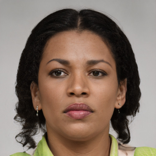 Neutral black young-adult female with medium  brown hair and brown eyes