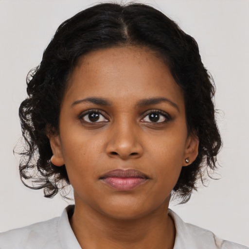 Neutral black young-adult female with medium  brown hair and brown eyes
