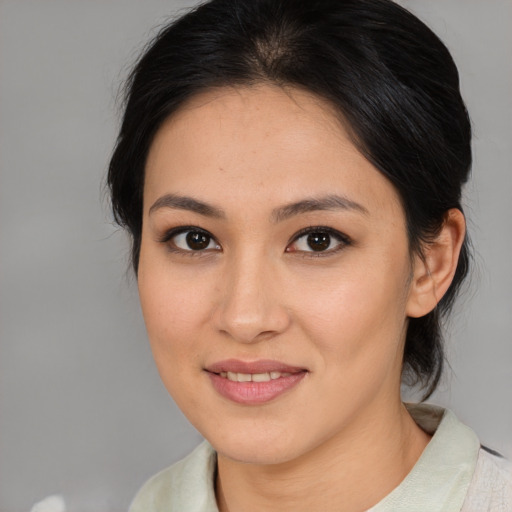 Joyful asian young-adult female with medium  brown hair and brown eyes