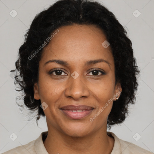 Joyful black adult female with medium  brown hair and brown eyes