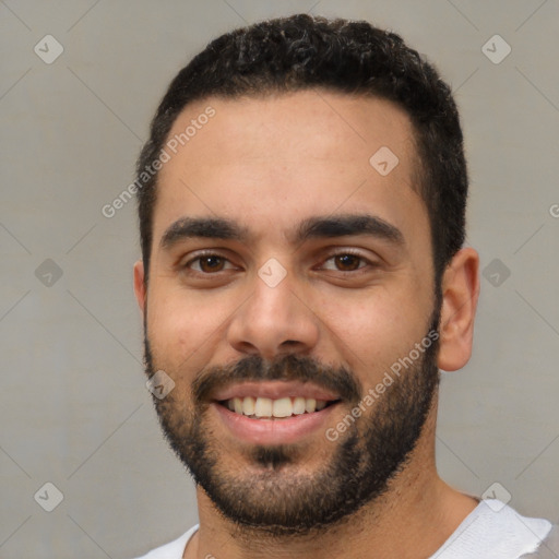 Joyful white young-adult male with short  black hair and brown eyes