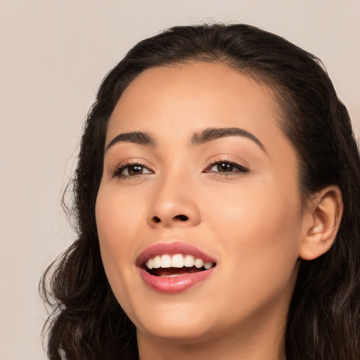 Joyful white young-adult female with long  black hair and brown eyes