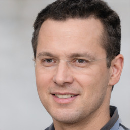 Joyful white adult male with short  brown hair and brown eyes