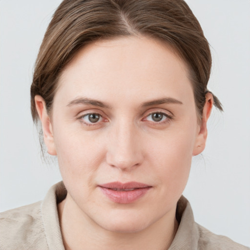 Joyful white young-adult female with medium  brown hair and blue eyes