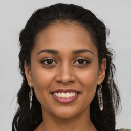 Joyful latino young-adult female with long  brown hair and brown eyes