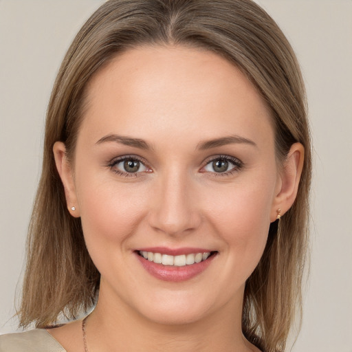 Joyful white young-adult female with long  brown hair and grey eyes