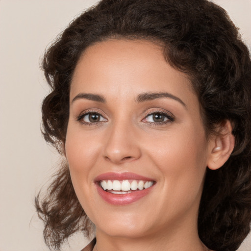 Joyful white young-adult female with medium  brown hair and brown eyes