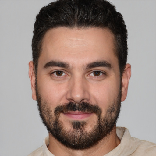 Joyful white young-adult male with short  brown hair and brown eyes