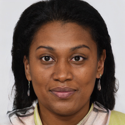 Joyful black adult female with medium  brown hair and brown eyes