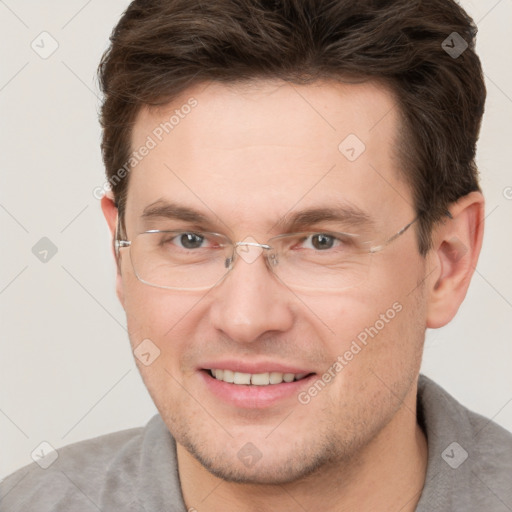 Joyful white adult male with short  brown hair and brown eyes