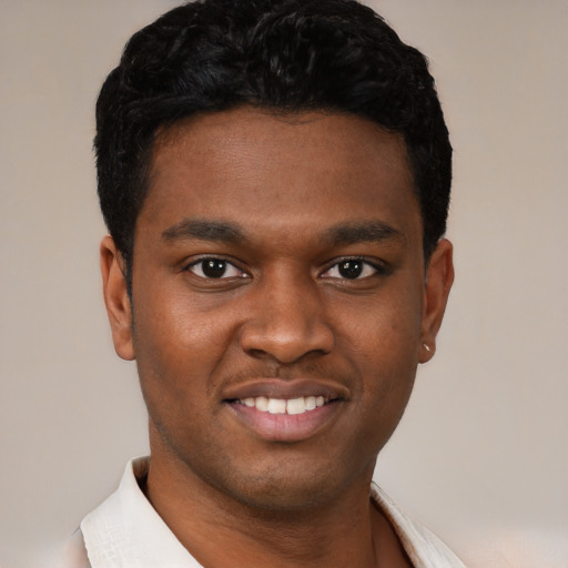 Joyful black young-adult male with short  black hair and brown eyes