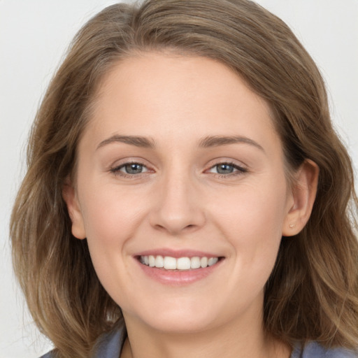 Joyful white young-adult female with long  brown hair and grey eyes