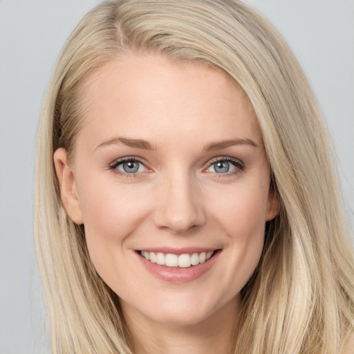 Joyful white young-adult female with long  brown hair and blue eyes