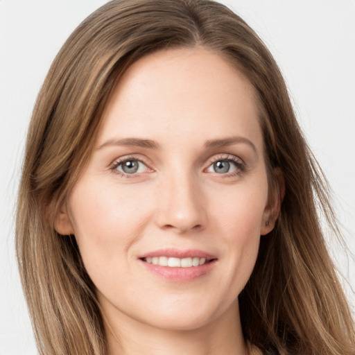 Joyful white young-adult female with long  brown hair and grey eyes