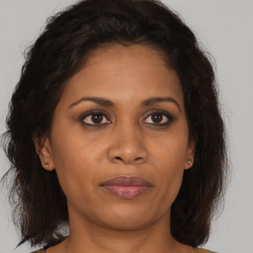 Joyful black adult female with medium  brown hair and brown eyes