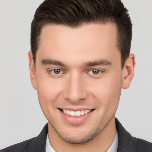 Joyful white young-adult male with short  brown hair and brown eyes