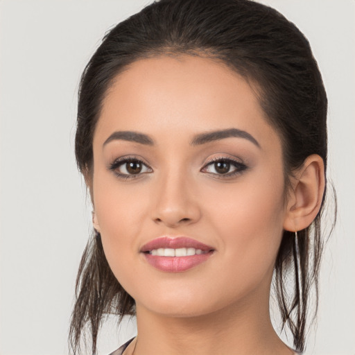 Joyful white young-adult female with long  brown hair and brown eyes