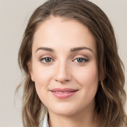 Joyful white young-adult female with long  brown hair and green eyes