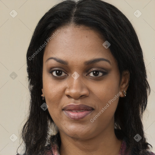 Joyful black young-adult female with long  black hair and brown eyes