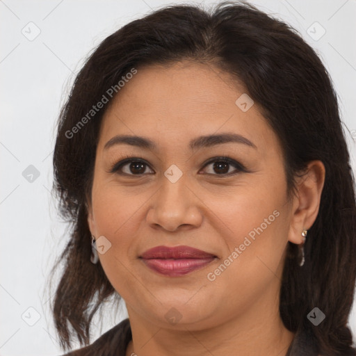 Joyful latino adult female with medium  brown hair and brown eyes