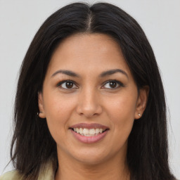 Joyful latino young-adult female with long  brown hair and brown eyes