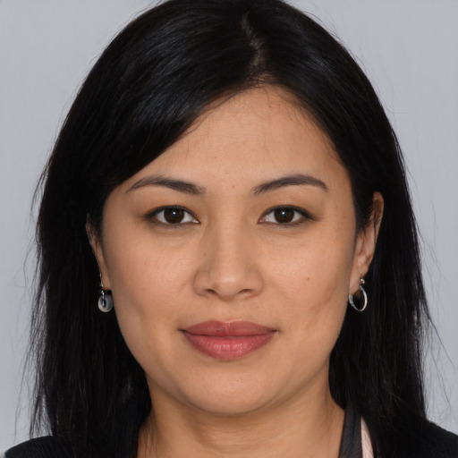 Joyful asian young-adult female with long  black hair and brown eyes