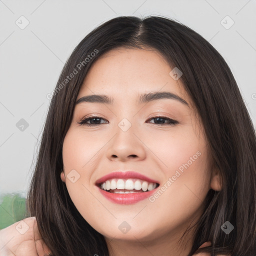 Joyful white young-adult female with long  black hair and brown eyes