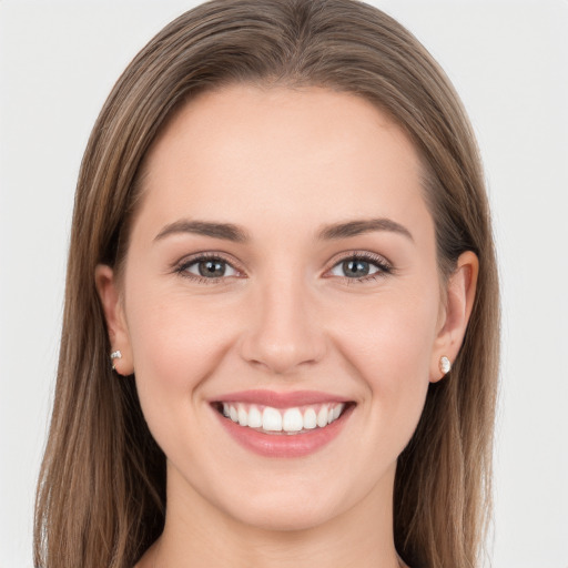 Joyful white young-adult female with long  brown hair and grey eyes