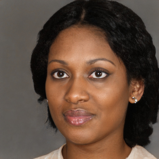 Joyful black adult female with medium  black hair and brown eyes