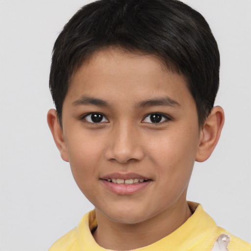 Joyful asian child male with short  brown hair and brown eyes