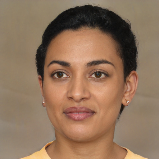 Joyful latino young-adult female with short  black hair and brown eyes
