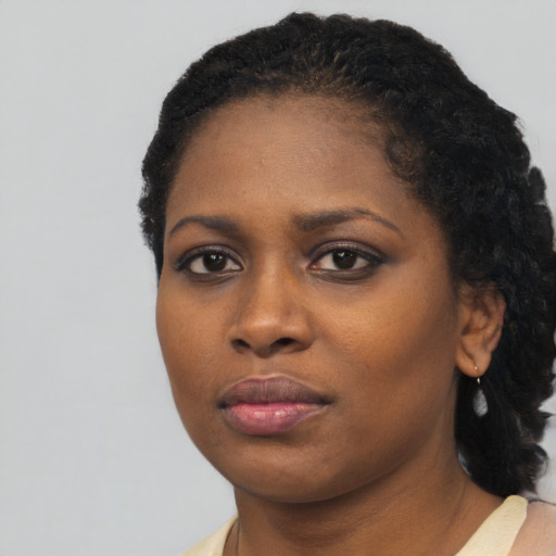 Neutral black young-adult female with medium  black hair and brown eyes