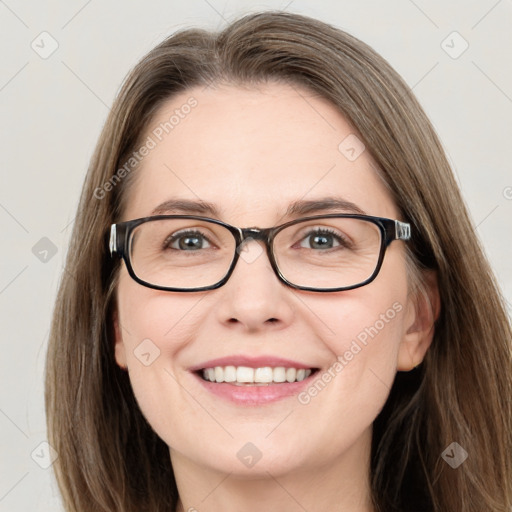 Joyful white adult female with long  brown hair and green eyes