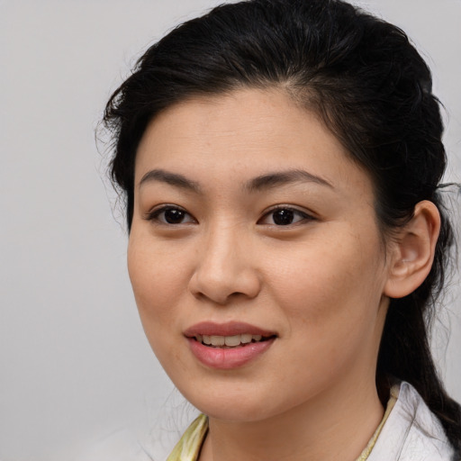 Joyful asian young-adult female with medium  brown hair and brown eyes