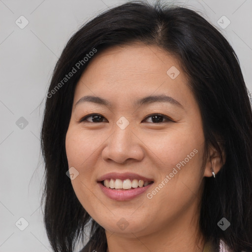 Joyful asian young-adult female with long  brown hair and brown eyes