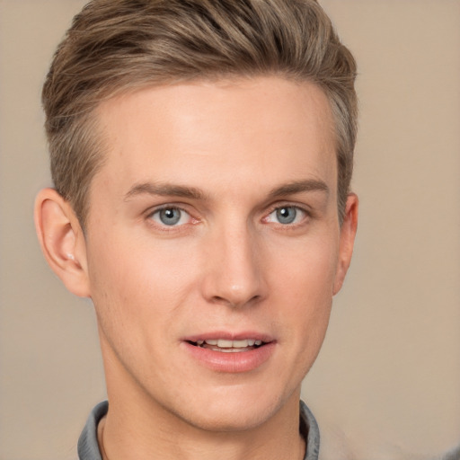 Joyful white young-adult male with short  brown hair and grey eyes