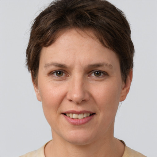 Joyful white adult female with short  brown hair and grey eyes