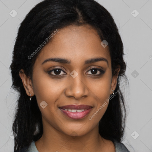 Joyful black young-adult female with long  black hair and brown eyes