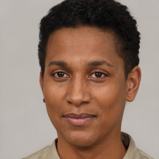 Joyful black adult male with short  black hair and brown eyes