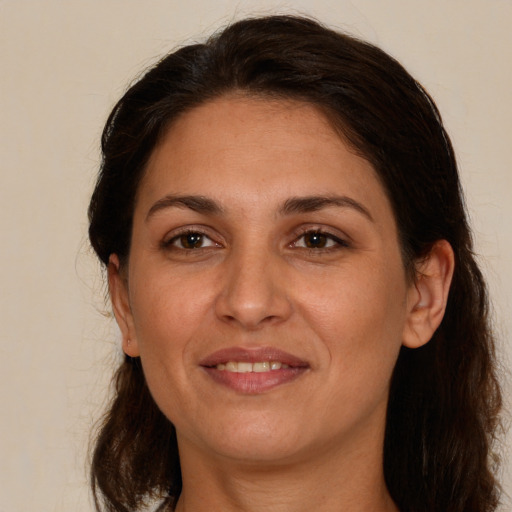 Joyful white adult female with medium  brown hair and brown eyes