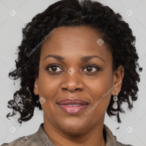 Joyful black adult female with short  brown hair and brown eyes