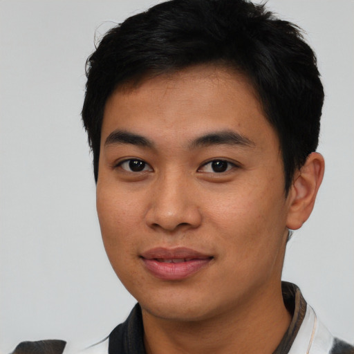 Joyful asian young-adult male with short  black hair and brown eyes