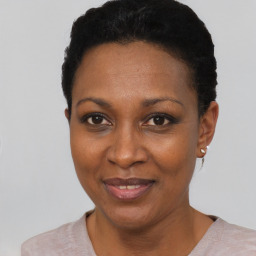 Joyful black young-adult female with short  black hair and brown eyes