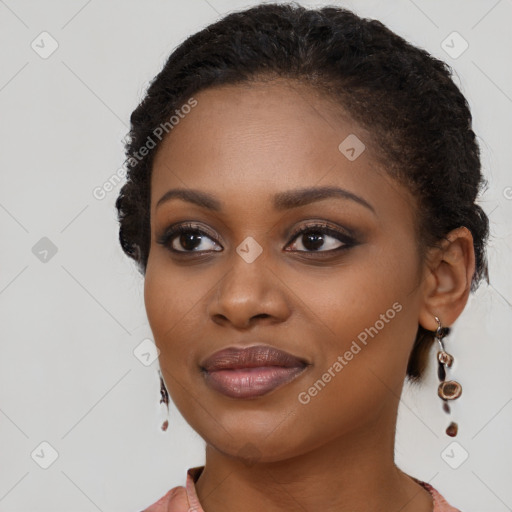 Joyful black young-adult female with long  brown hair and brown eyes